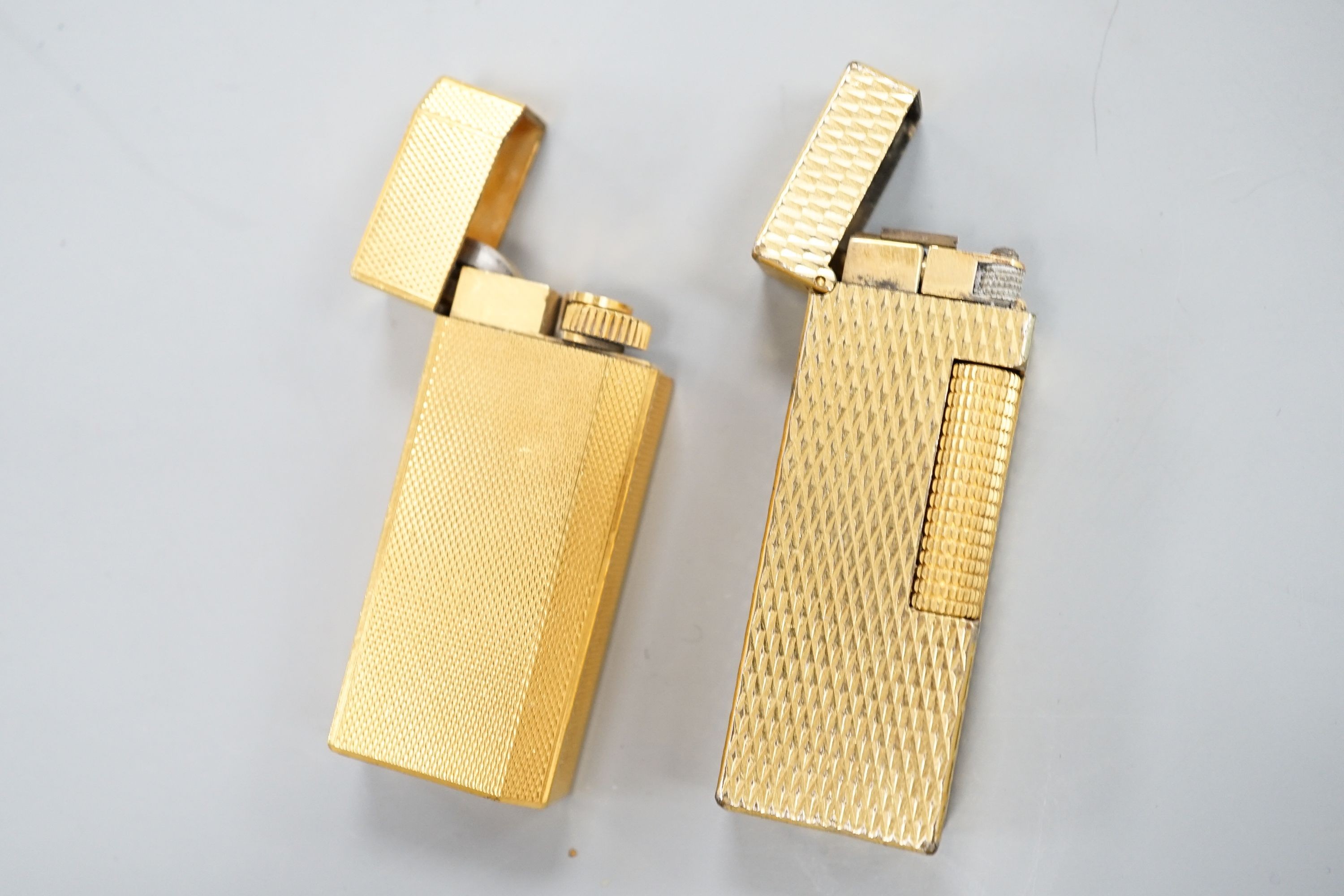 A gold plated Cartier lighter and a similar Dupont lighter